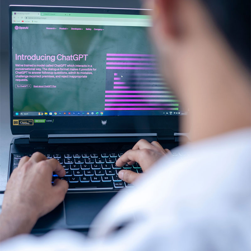 man-on-computer-with-ChatGPT-on-screen - AI at Work